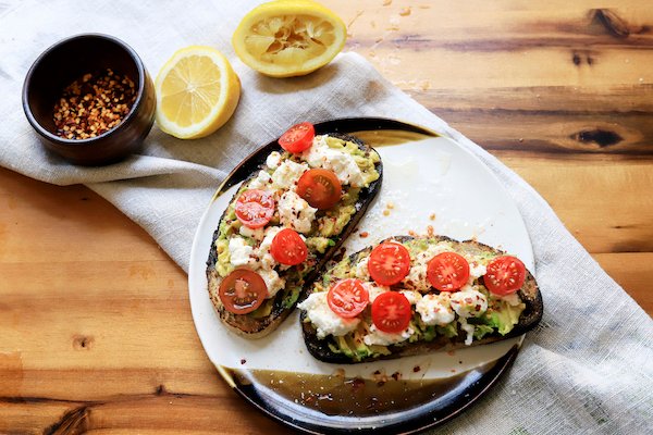 Image of Smash avocado in a bowl and spread among toasted bread...
