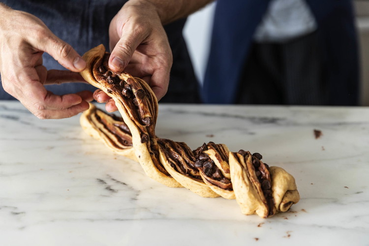 Image of Twist the two halves together, keeping the exposed chocolate layers facing up, and push in the ends to form a 9-inch-long twist.