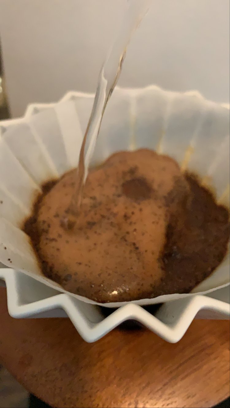 Image of Add the fresh coffee grounds to the filter and swirl...