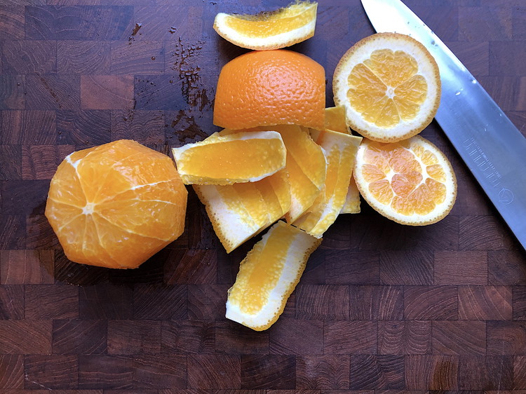 Image of Rest a cut side on your cutting board, and following the curve of the orange, remove the peel and pith, slicing from top to bottom.