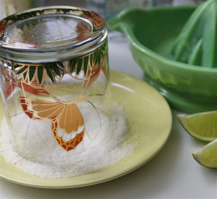 Image of Dip rim of glass into salt and add as much...