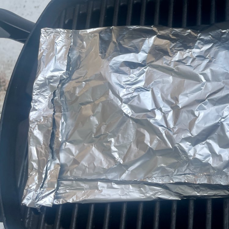 Image of Place the packet on the grill and cook, flipping halfway,...