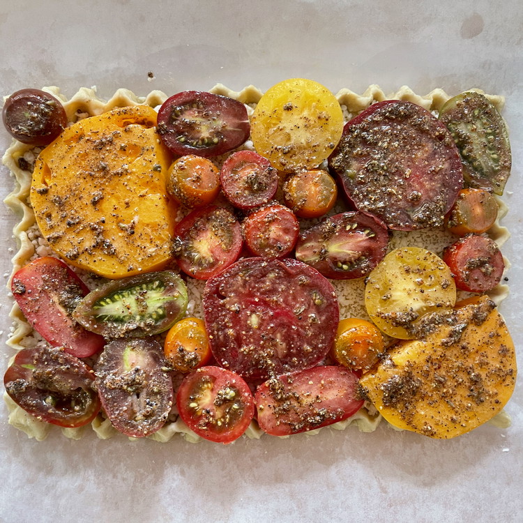 Image of In a small bowl mix all of the remaining filling ingredients well to combine.  Brush over the tomatoes in the tart using all of the mixture and making sure all tomatoes getting a brushing of the seasoning liquid.