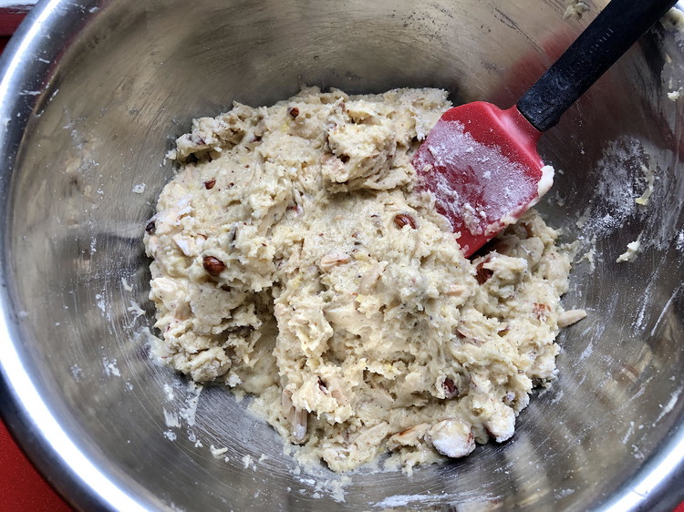 Image of Stir the flour and the nuts in with a spatula and mix until no floury bits remain.