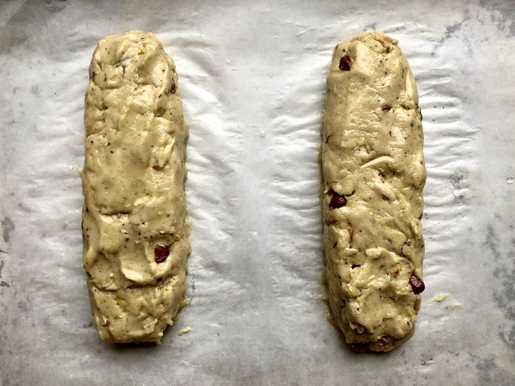 Image of Divide the sticky dough into two equal pieces in the bowl, then wet your hands with cold water, remove half, and shape an even log on the baking sheet. Rinse your hands, then repeat with the other half, making sure...