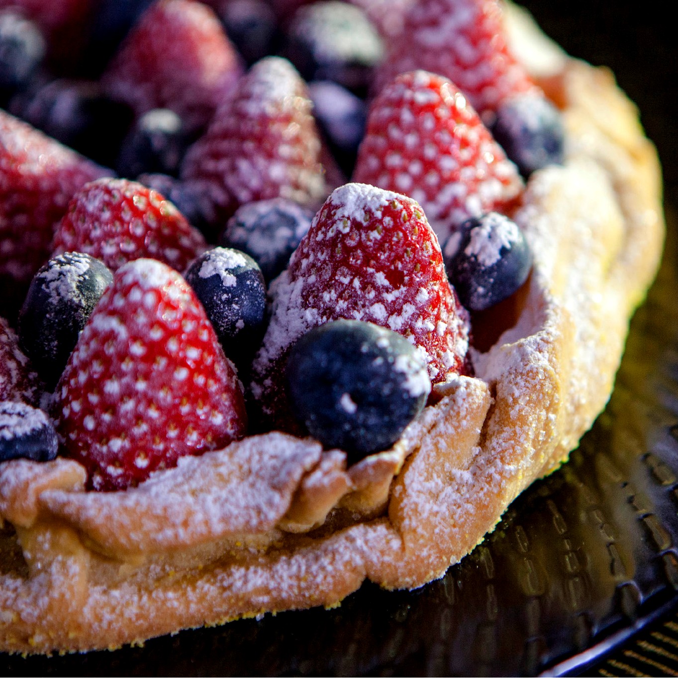 https://images.getrecipekit.com/20210829235422-strawberry-blueberry-galette.jpg?aspect_ratio=1:1&quality=90&auto_optimize=medium