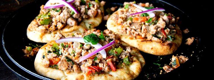 Image of Top with thin slices of red onions and a squeeze...