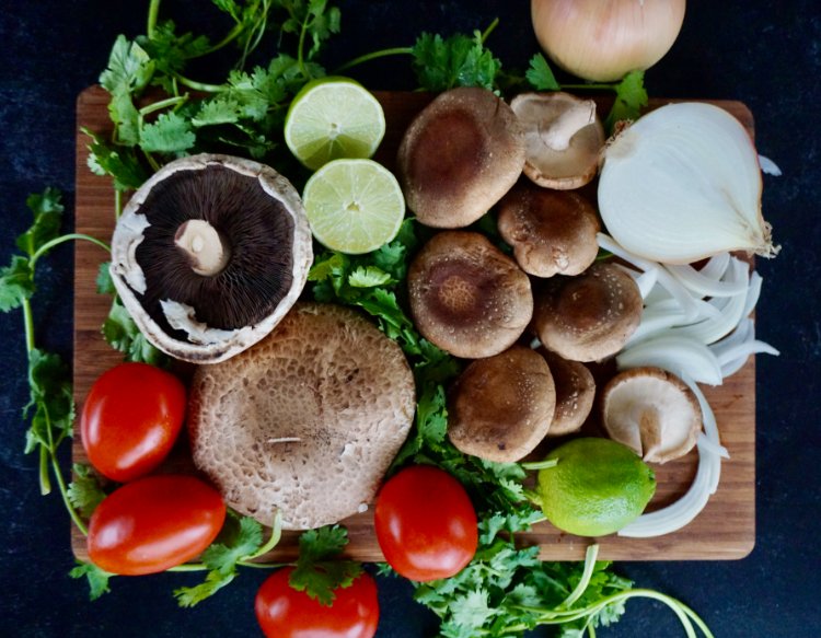 Image of Dice the shiitake and portabella mushrooms into small cubes. Chopping...