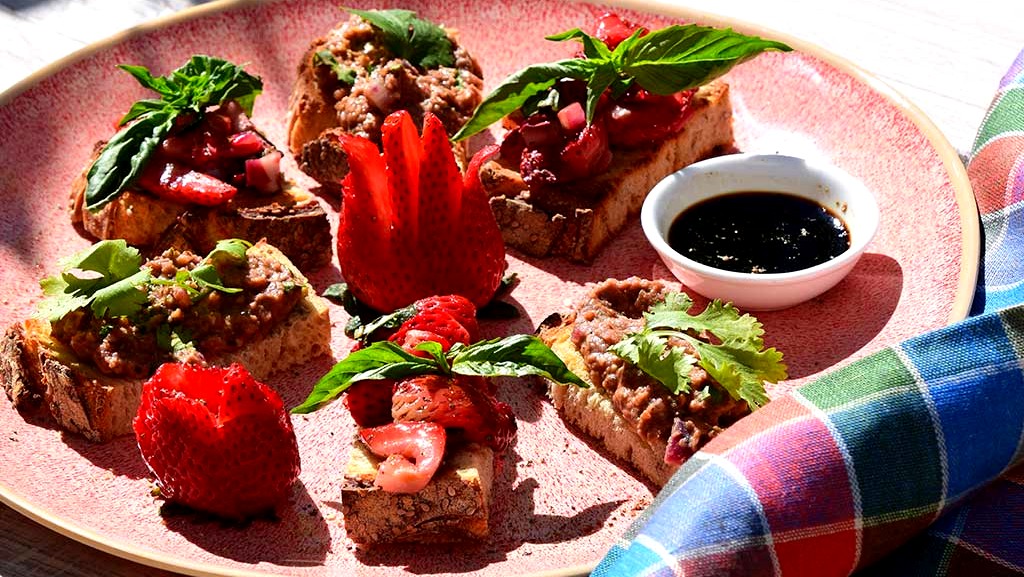 Image of Roasted Strawberry Bruschetta with Cardamom Scented Hummus and Walnut Lentil Spread