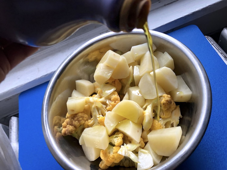 Image of Toss the potato and cauliflower pieces with olive oil, the remaining Chaat Masala spice and salt in a bowl to evenly coat, then add to the pan with onions and mix everythig up.