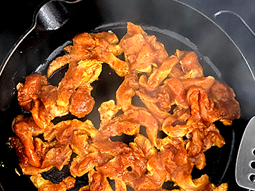 Image of Using tongs or your hands, add the chicken to the...