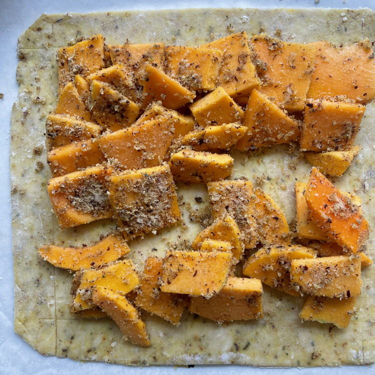 Image of Layer the slices inside of the square you scored (1” from the edges). Arranging them all roughly in the same direction (like the top left corner in the picture) helps the pieces cook more evenly than just piling them in...