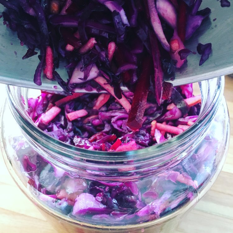Image of Pack the cabbage into your fermentation jar tightly using your...