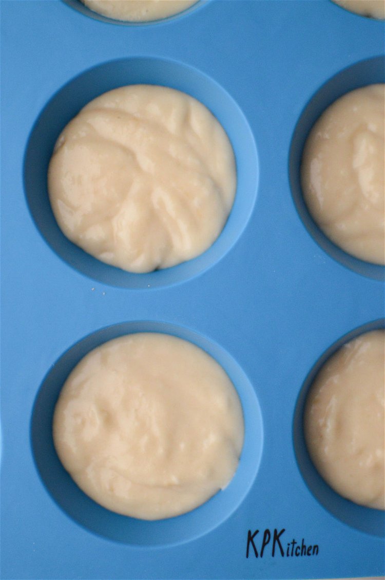 Image of Divide the cupcake batter evenly, filling each cavity roughly 2/3...