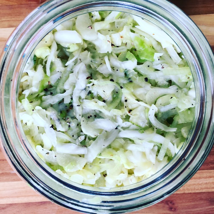 Image of Pack the cabbage into your fermentation jar tightly using your...