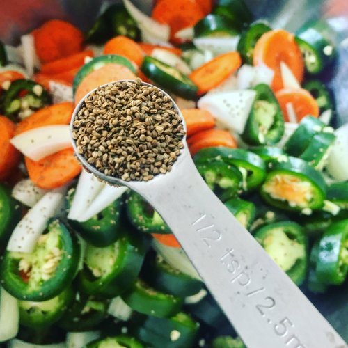 Image of In a large mixing bowl, combine jalapeños, carrot, onion and...