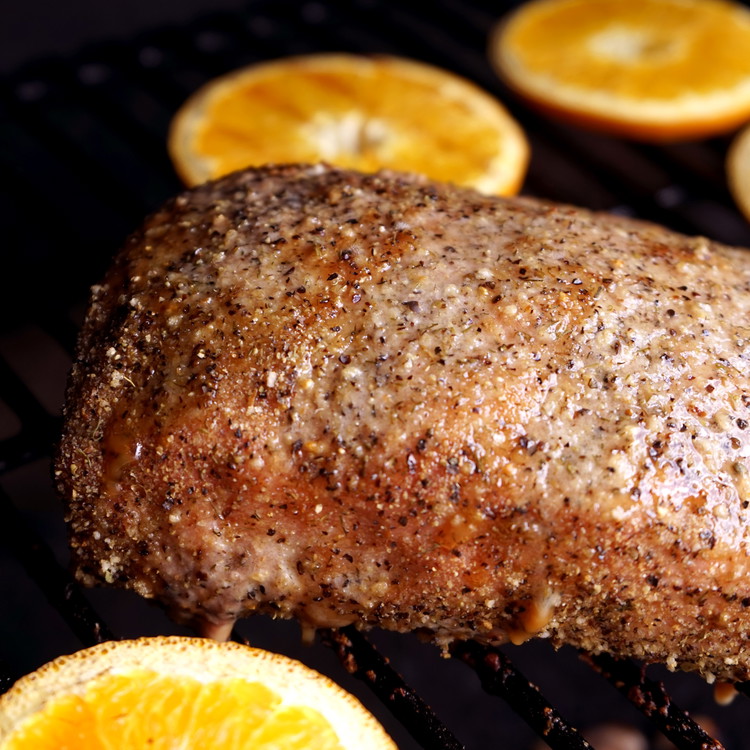 Image of Remove the pork from the smoker and allow to rest for 15mins. brush the sauce across the top of the roast. You can set aside any extra sauce to serve along with the roast. 