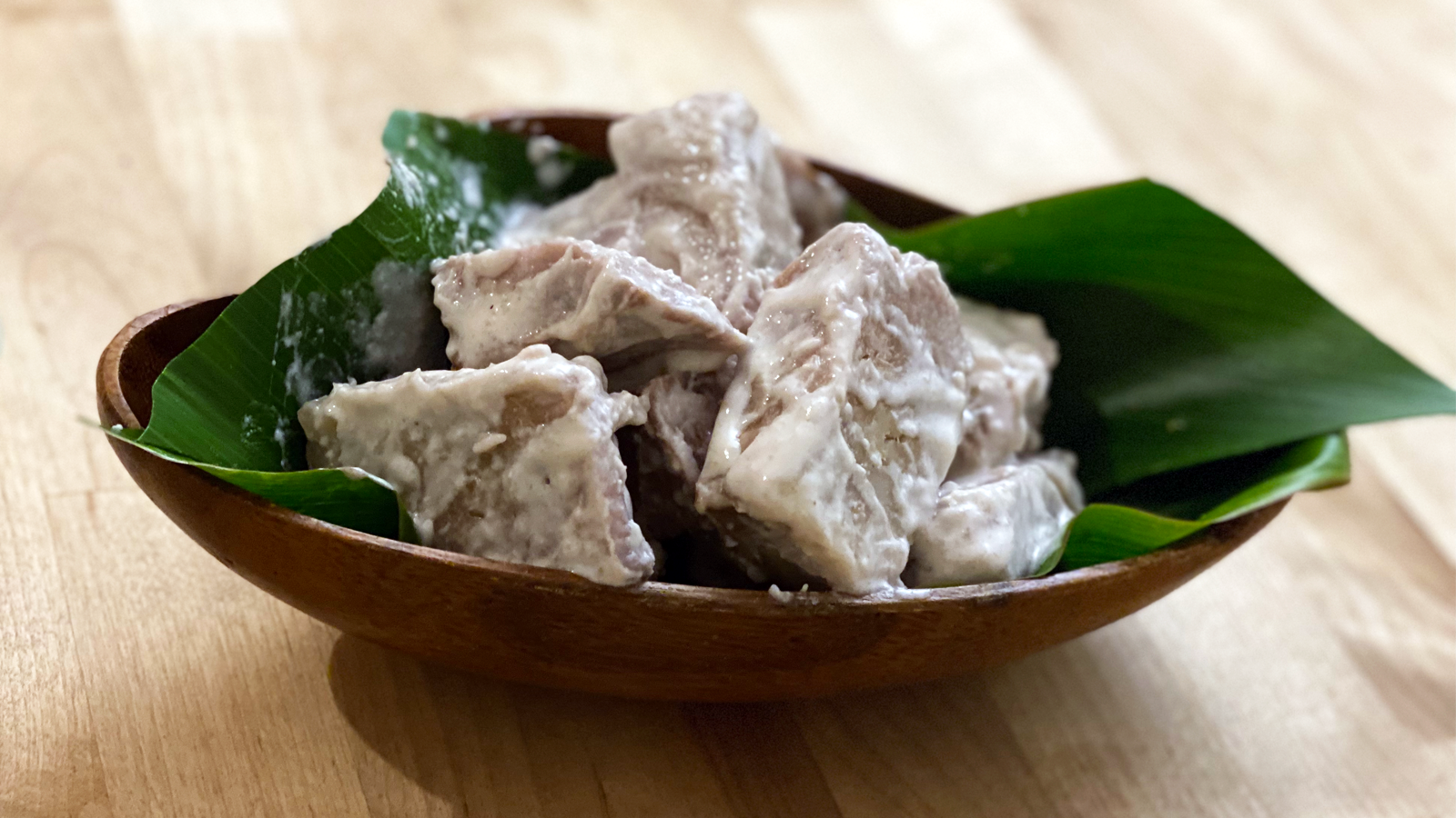This dish is beautifully served with ti leaves in a wooden bowl