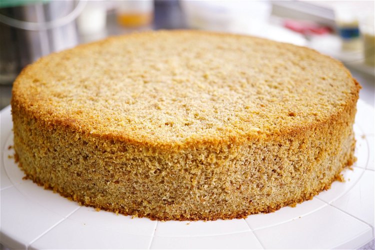 Image of Trim the edges and top of the cake with a...