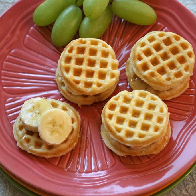 https://images.getrecipekit.com/20211108205657-mini-waffles-with-banana-and-honey-1024x685.jpg?aspect_ratio=1:1&quality=90&