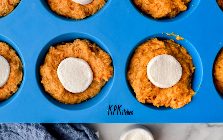 Image of Divide HALF the batter evenly into each muffin cup, filling...