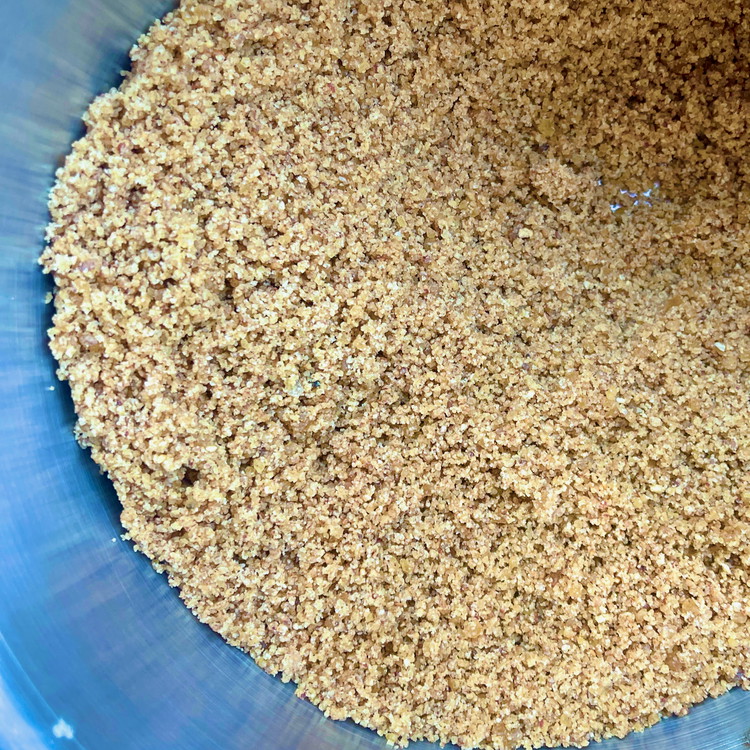 Image of When the pecan caramel has cooled, pulse it in a food processor to a crumbly wet sand texture.  