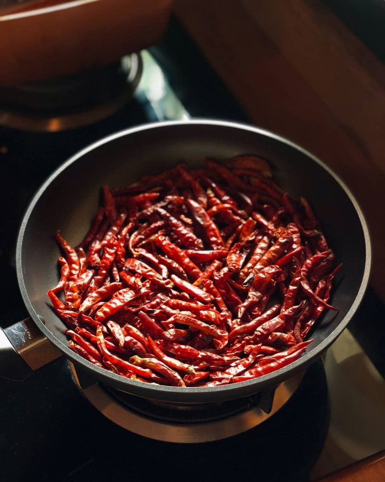Image of Add the chilies and salt into a pan on low...