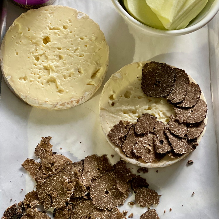 Image of Layer the truffle slices evenly onto the bottom disk of cheese and season lightly with salt.
