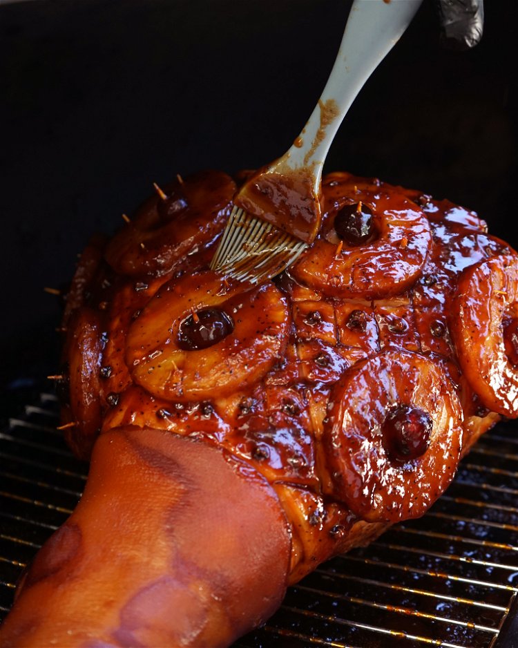 Image of Place the ham on the pellet smoker rack in a...