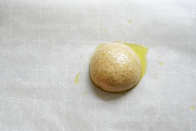 Image of Place the dough ball on top, drizzle a little more...