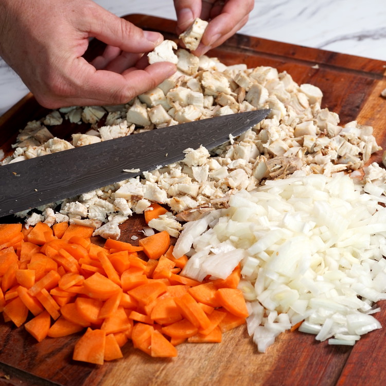 Image of Chop the turkey, vegetables and brie into bite sized pieces and add to a large bowl.