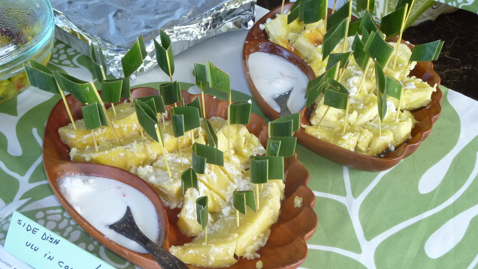 ʻUlu chunks with coconut leaf sample sticks and coconut cream on the side.