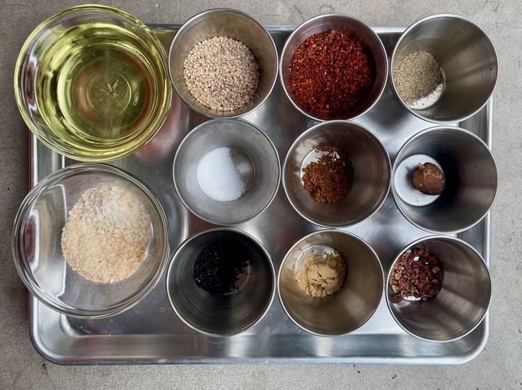 Image of In a heatproof bowl, combine the salt, sugar, Aleppo, urfa, star anise, black pepper, ginger, red cardamom, and Sichuan pepper if using.