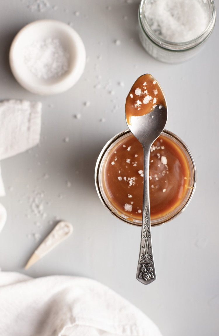 Image of Pour the sugar into a large, heavy bottom pot and turn onto medium-low heat. Using a whisk, stir frequently as the sugar melts. The sugar will start to clump together as it melts. As soon as the sugar has completely...