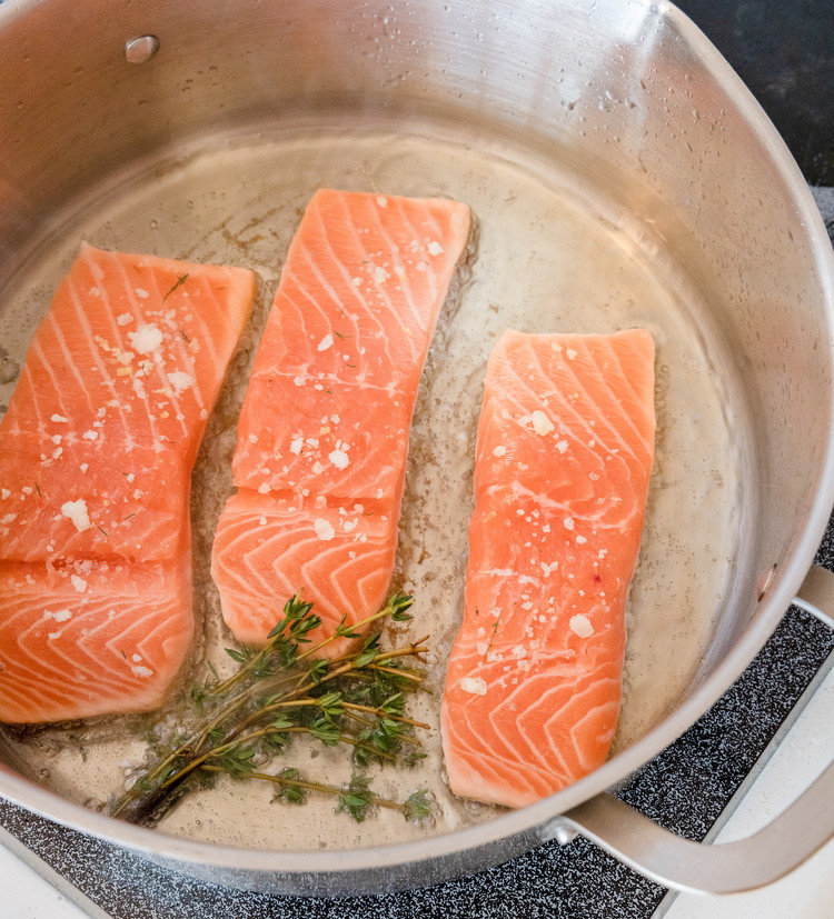 Image of Gently place each salmon fillet in the pan, leaving adequate space between the pieces. Once the pieces are in the pan, do not move them around—they will naturally release and be movable once a crust develops. Drop the temperature to...