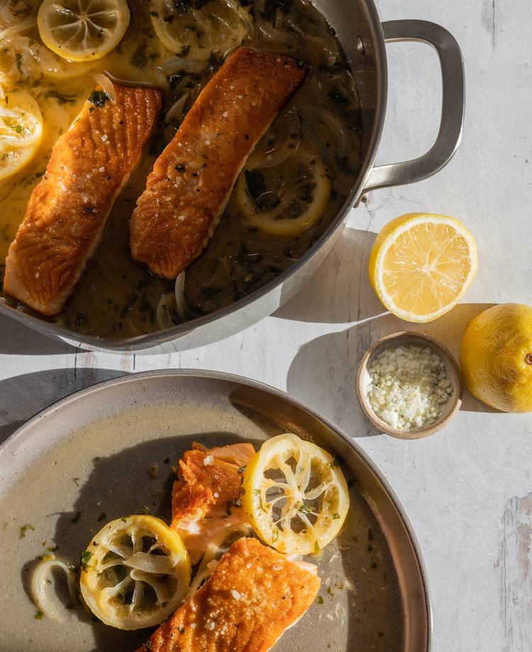 Image of Cook on medium heat until the onions are just barely tender and the sauce has slightly thickened; add the salmon fillets back to the pan (seared side up) to finish cooking through—about four minutes or so.