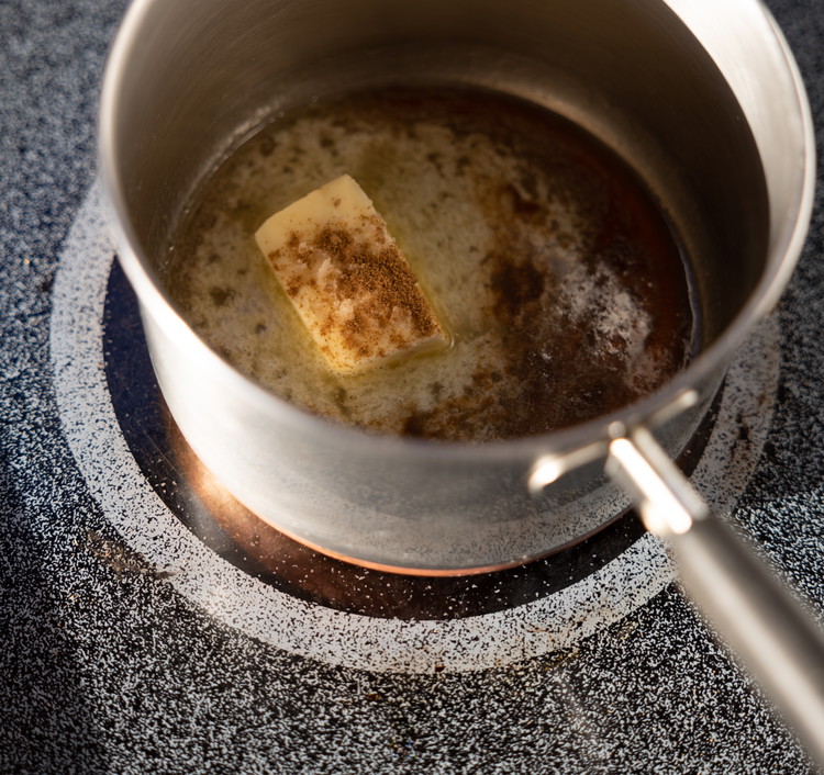 Image of Preheat oven to 325 F. 1.    In a small sauce pan combine the butter, maple syrup, cumin, and a sprinkle of smoked salt over medium heat and stir occasionally until the butter is melted.