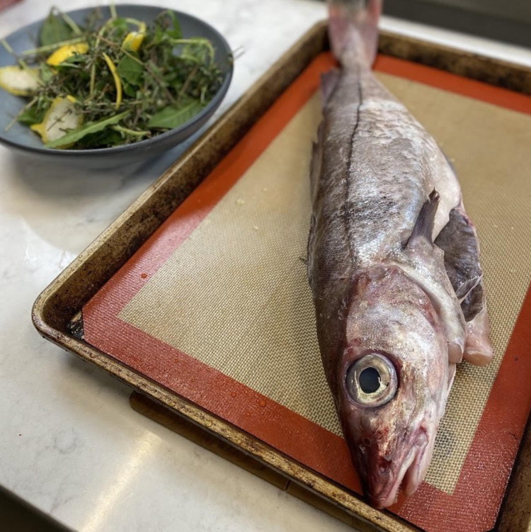 Image of Choose a large rimmed baking sheet, roasting pan or casserole dish large enough to fit your fish with plenty of space. Place enough salt mixture on the bottom of the baking sheet to cover a space roughly the size and...