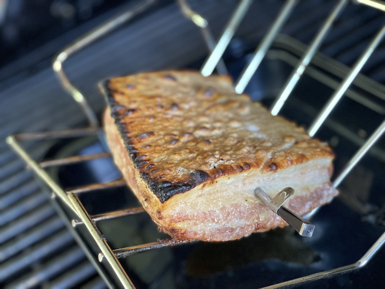 Image of Pre-heat your BBQ or oven to 450F/230C. Place your pork belly on an angled roasting rack, as this will prevent liquid pooling on the skin and ruining the crackling. 