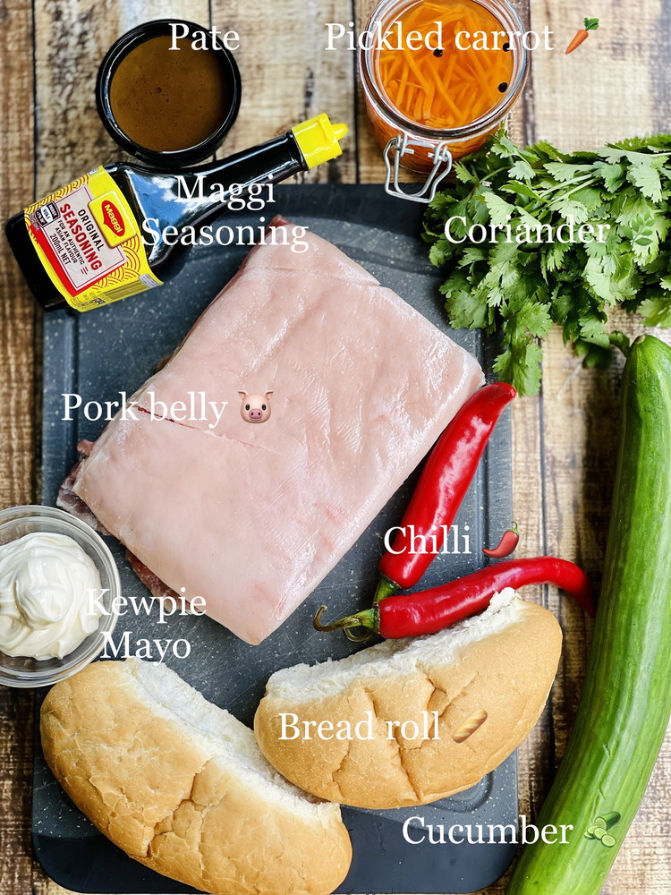 Image of Then spread the kewpie mayo and pate inside the roll, then 4-5 slices of that melt in the mouth pork belly, cucumber, spring onion, coriander and chilli.
