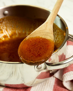 Image of in a saucepan over a low heat, melt and combine 50g of butter with 1/2 cup of Lane's One Legged Chicken.  