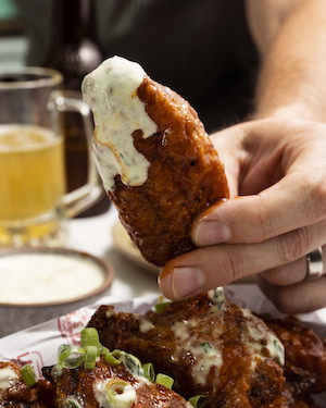 Image of Toss the wings in the warm sauce then plate up and eat immediately. 