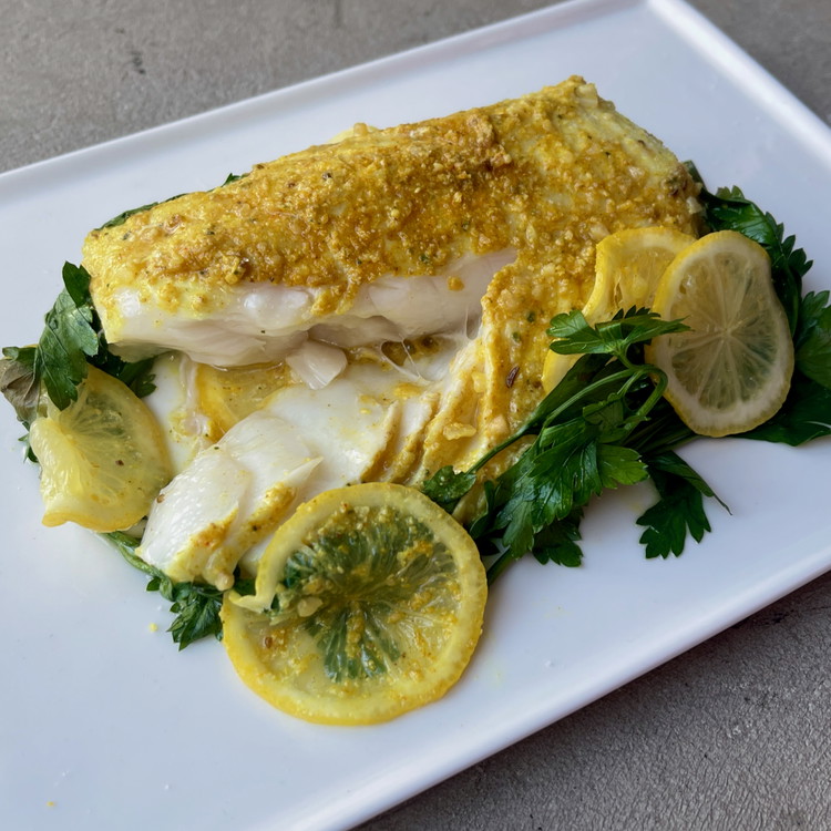 Image of Serve with fresh lemon, a sprinkle of parsley, and a little fleur de sel to season the cod flakes as they delicately unfold at each forkful.