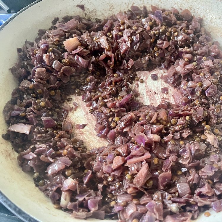 Image of Continue cooking, stirring occasionally, until the cabbage is caramelized.