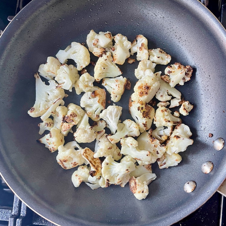 Image of In a 10” nonstick pan, heat 2 tablespoons of olive oil with the cauliflower florets on high heat.  Caramelize the cauliflower, tossing occasionally.