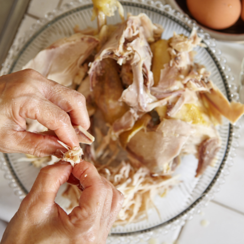 Image of Shred the chicken with fingers or using 2 forks.