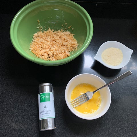 Image of Let chicken cool slightly and combine with a beaten egg, panko (or parmesan as mentioned below) and seasoning in a large bowl.