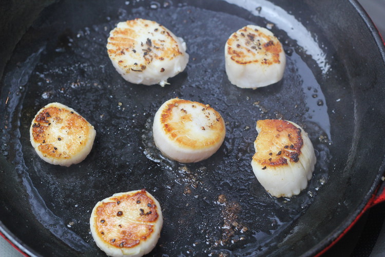 Image of Cook for two minutes, then flip the scallops. Season other side after you flip and cook for another two minutes. 