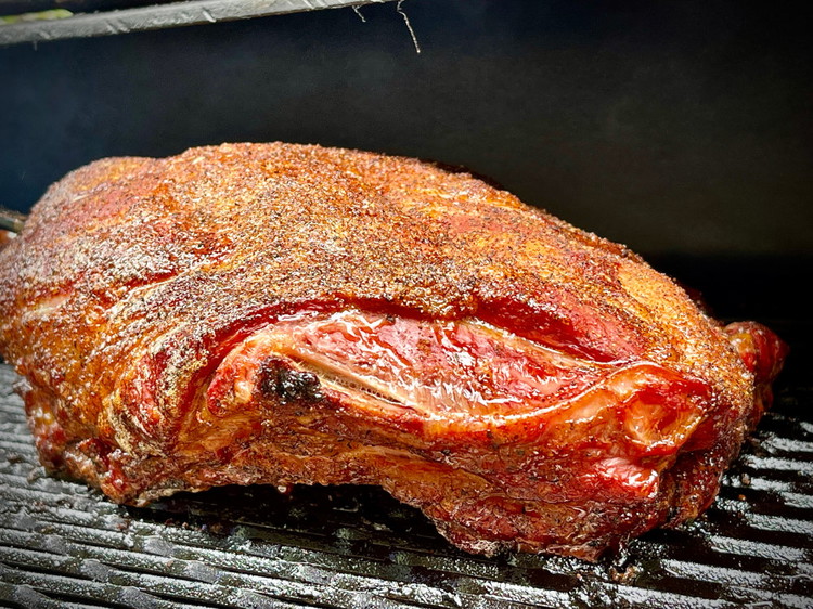 Image of Once your smoker is approx 275F/135C place your lamb inside and smoke for 3-4 hours or until the skin has taken on a deep ruby red colour and the bark has formed.
