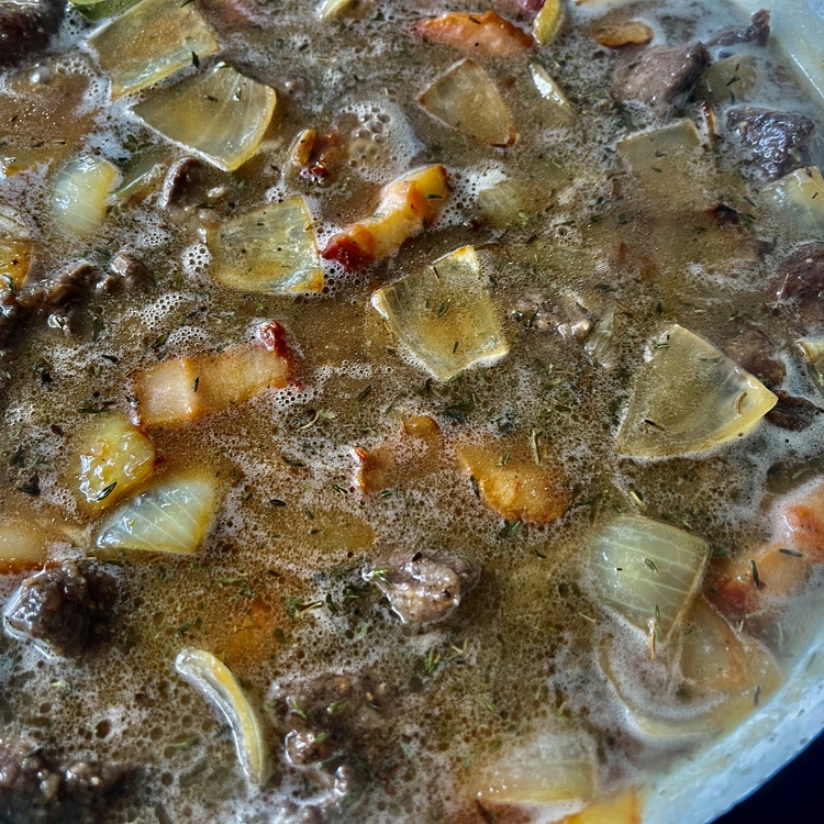 Image of Bring the pot to a boil, skim any foamy bubbles, and reduce the heat to simmer for 2 hours or until the beef is tender.